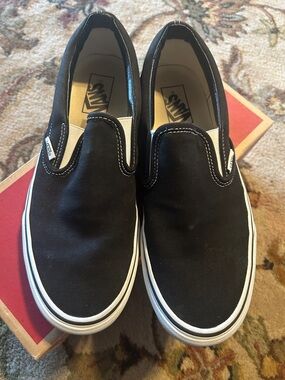 Like new in box. Vans Black & White Classic Slip-On Canvas Mens 9 women 10.5
